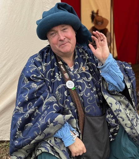 A festival attendee smiling in full Renaissance clothing